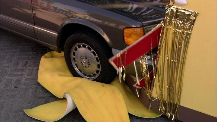 but the car  hit Gob's banana peel.