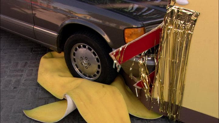 but the car  hit Gob's banana peel.